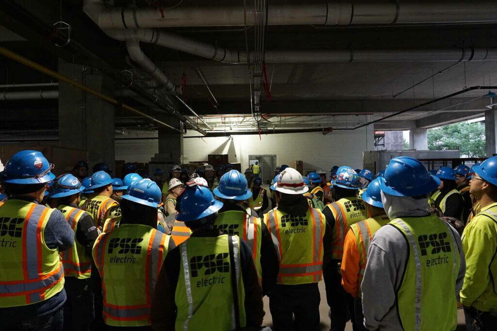 Group of workers gathered to listen to a safety talk