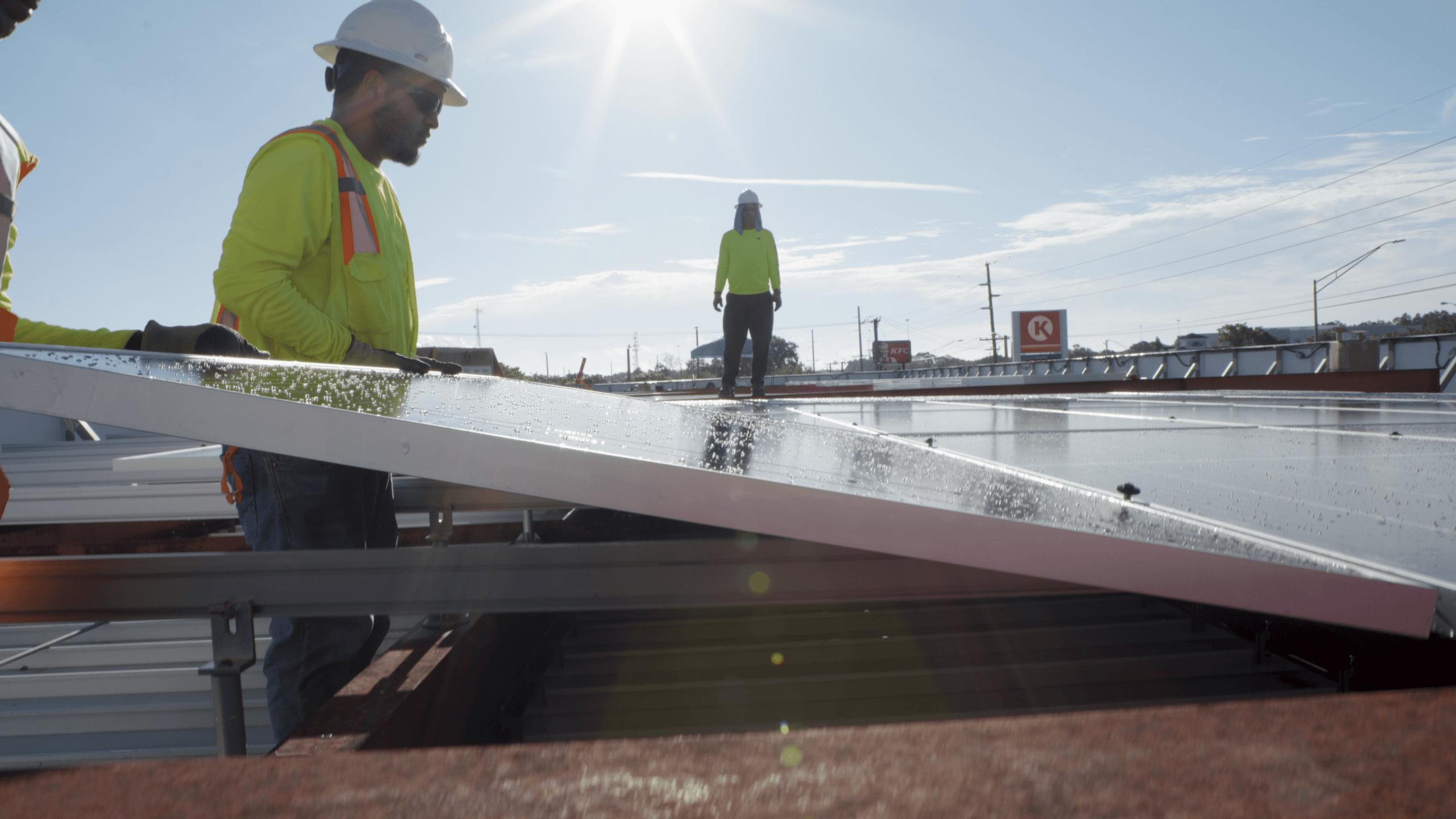 techs installing solar panel on roof