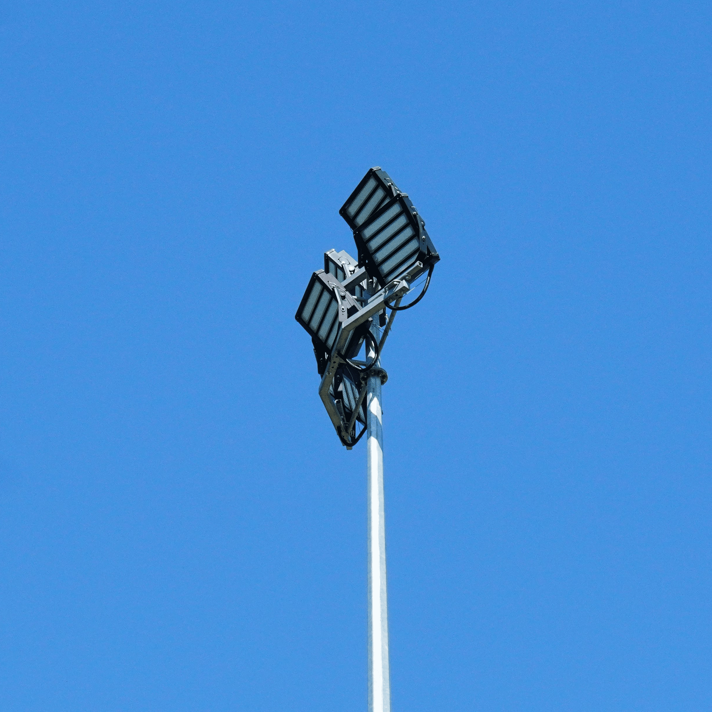 LED light fixtures on top of a pole overlooking sports field